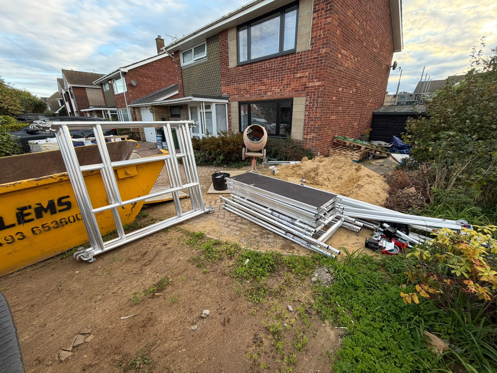 Leader Pro aluminium scaffold tower components, frames, platforms, braces and castors delivered to a residential building site.