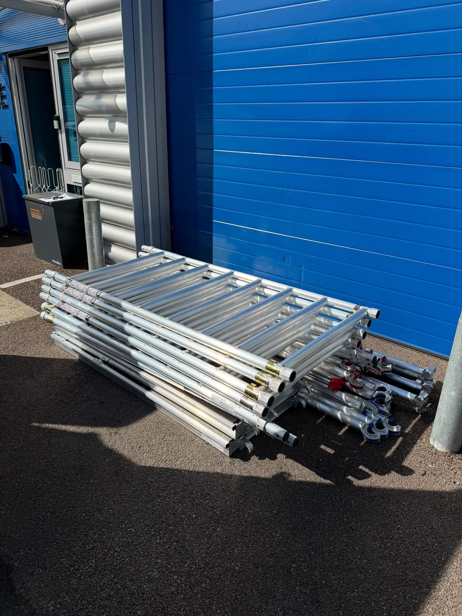 Leader Pro aluminium scaffold tower frames, braces and components stacked and ready for delivery.