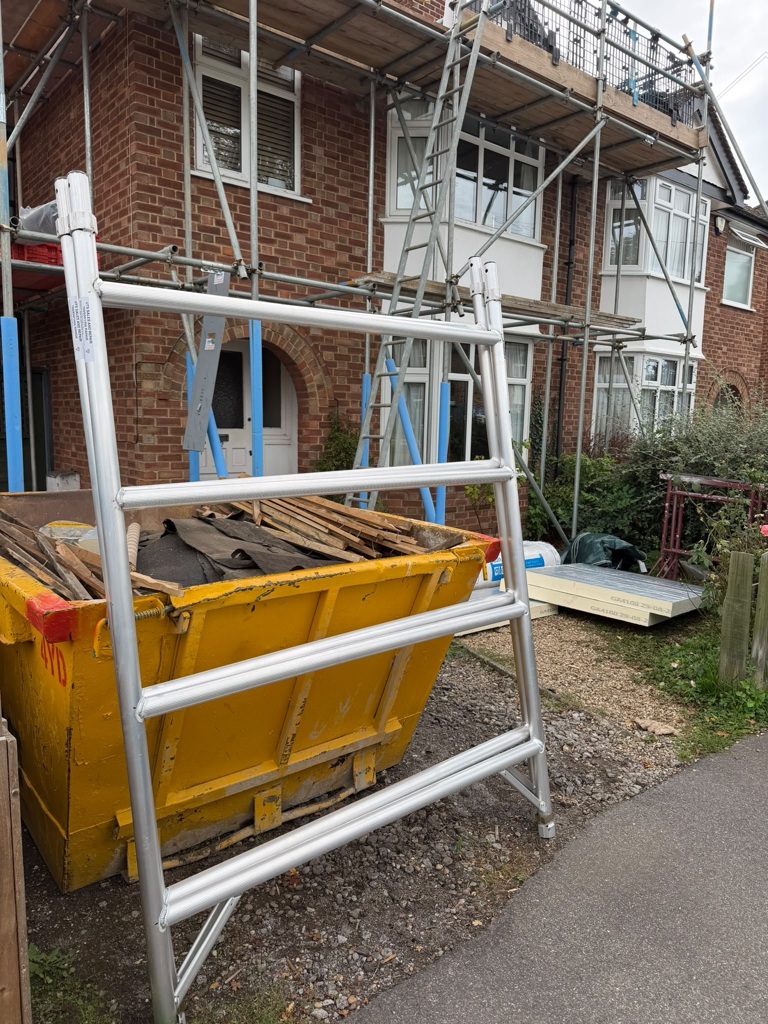 Leader Pro aluminium scaffold tower frame delivered to a residential building renovation site with scaffolding in place.