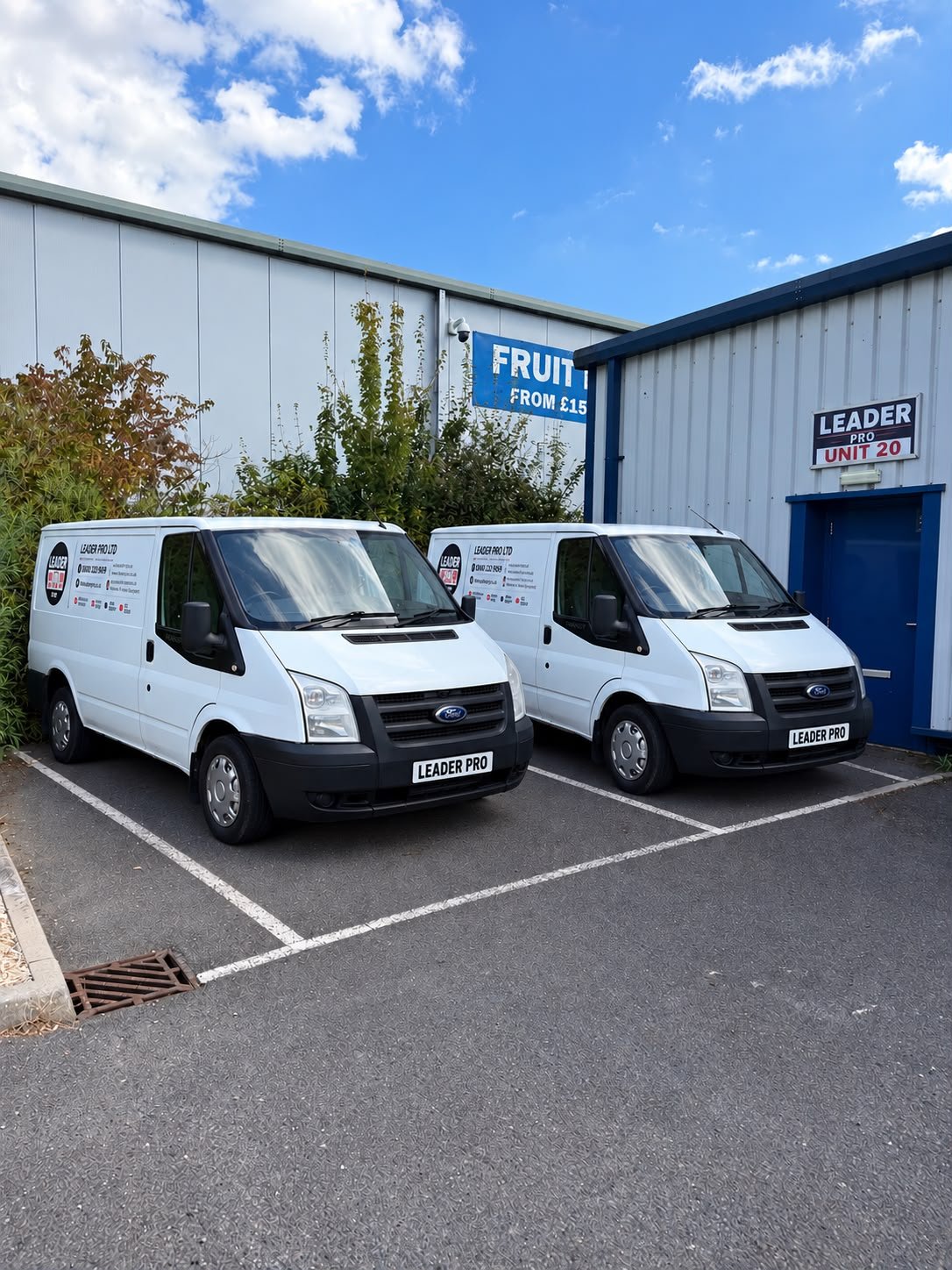 Two branded Leader Pro scaffold tower delivery vans parked outside the Leader Pro warehouse in Canterbury, Kent.